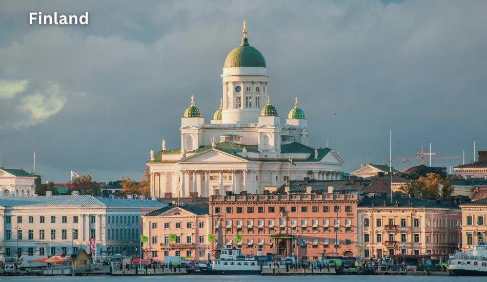 Sunlit view of Helsinki Cathedral rising above the waterfront buildings, showcasing Finland as one of the best countries to migrate for high-quality education, innovation, safety, and a globally recognized standard of happiness.