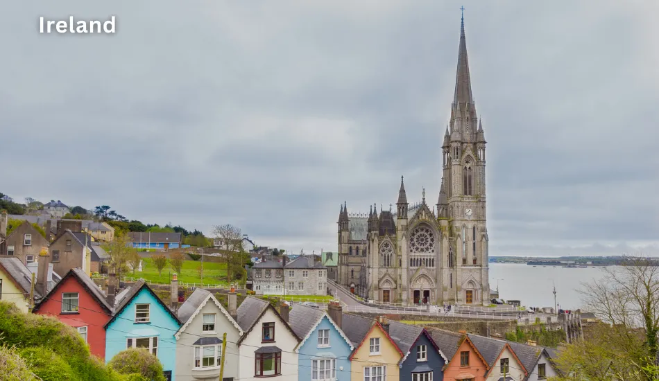 View of St. Colman’s Cathedral in Cobh overlooking vibrant row houses and the harbor, reflecting Ireland as one of the best countries to migrate for tech jobs, EU access, and a welcoming, English-speaking environment.