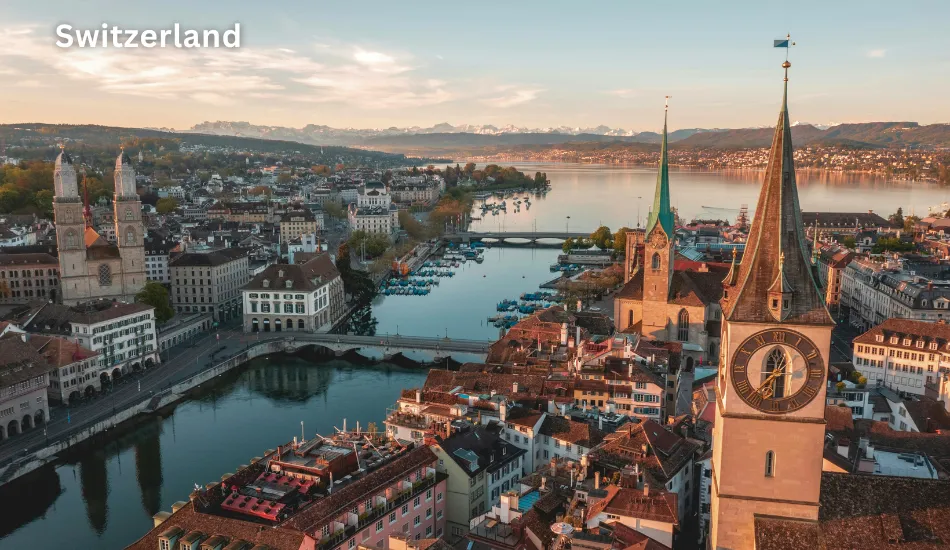 Aerial view of Zurich featuring historic churches, Lake Zurich, and the Swiss Alps in the background, highlighting Switzerland as one of the best countries to live in future for high salaries, safety, and a future-proof lifestyle.