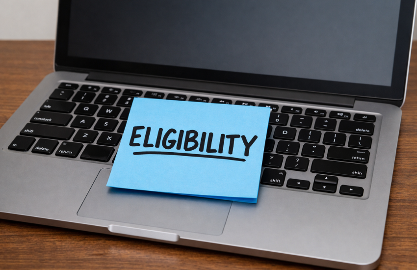 Eligibility criteria note on laptop keyboard representing Australia PR age limit, IELTS score, skills assessment, and points system requirements explained by Australia immigration consultant in Ahmedabad