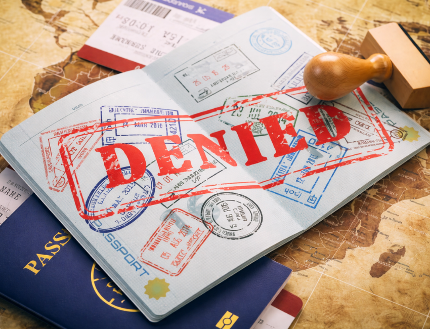 Passport with denied visa stamp highlighting common visitor visa rejection reasons explained by the best visitor visa consultant in Ahmedabad to prevent application mistakes